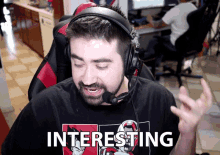 a man wearing headphones and a shirt that says " interesting "
