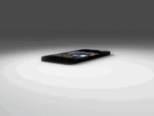 a cell phone is laying on a white surface