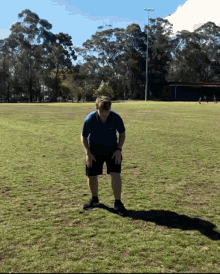 a man wearing a blindfold is standing in a field