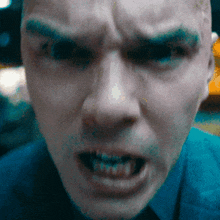 a close up of a man 's face with a very angry look on his face