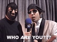 a man holding a microphone with the number ten on it