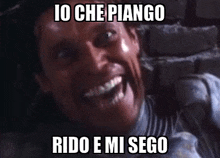 a man is making a funny face with the words `` io che piango rido e mi sego '' .