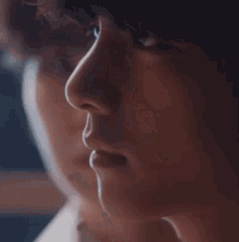 a close up of a person 's face with a reflection of another person .