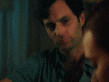 a man is holding a glass of red wine