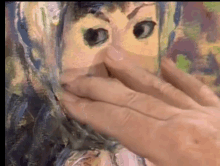 a person is covering their mouth in front of a painting