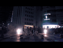 a man in a black and white striped shirt is giving a peace sign