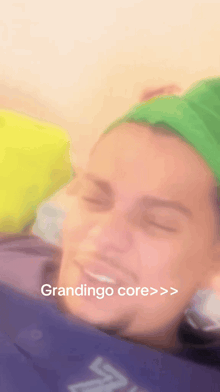 a man wearing a green headband with the words grandingo core on the bottom