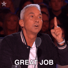 a man in front of a microphone giving a thumbs up with the words great job below him