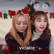 two girls are hugging each other and the word viclaire is on the bottom of the picture