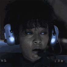 a woman wearing a pair of headphones with a microphone attached to it