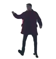 a man in a red coat and black pants is dancing