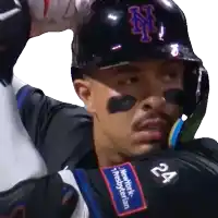 a man wearing a new york mets helmet and jersey