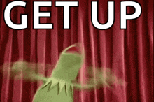 kermit the frog is standing in front of a red curtain with the words get up written on it