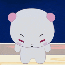 a white teddy bear with pink ears is standing in front of a blue background
