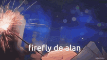 a person holding a sparkler with the words firefly de alan written on it