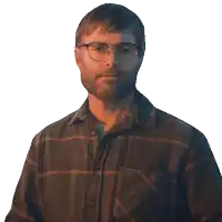 a man wearing glasses and a plaid shirt