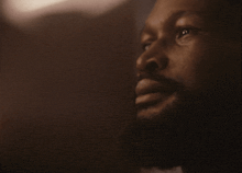 a man with a beard looks up at something