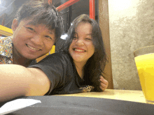 a man and a woman are posing for a picture and the man is wearing a shirt that says " daddy "