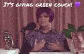 a woman with purple hair is sitting in front of a microphone with the words it 's giving green couch above her