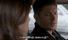 a man and a woman are sitting in a car and talking .