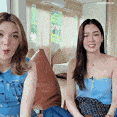 two women are sitting next to each other in a living room with the words lingor files written on the bottom