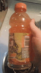 a person is holding a bottle of gatorade