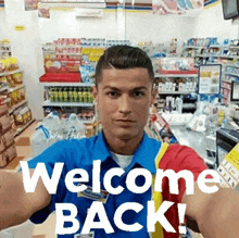 a man taking a selfie in a store with the words welcome back on the bottom