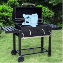 a black barbecue grill with a blue item on top of it