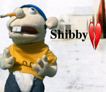 a stuffed animal with a pencil in his mouth and the word shibby on the bottom