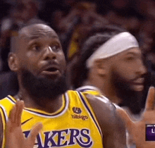 a basketball player with a beard wearing a yellow lakers jersey .