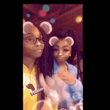 two girls are posing for a picture and one of them has a sticker that says " furboo "