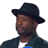 a man wearing a black hat says yeah in white letters