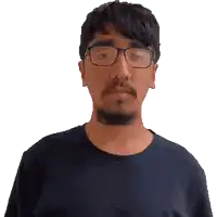 a man with glasses and a beard is smiling for the camera