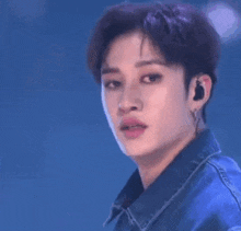 a close up of a person 's face with a mickey mouse glove on their hand .