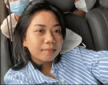 a woman wearing a blue and white striped shirt