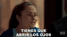 a woman says tienes que abrir los ojos