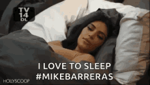 a woman is sleeping in a bed with a caption that says `` i love to sleep # mikebarrieras '' .