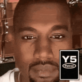 a close up of a man 's face with a y5 patrol logo in the background