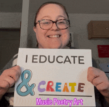 a woman holding up a sign that says i educate & create music poetry art