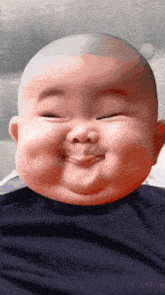 a baby with a bald head making a funny face with his eyes closed