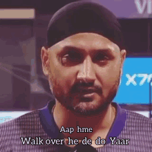 a man with a beard is wearing a black hat and says walk over he de do yaar