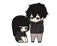 a boy is petting a girl 's head while she sits on the floor