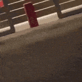 a wooden fence with a red box behind it