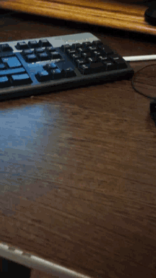 a black keyboard with a blue key that says ' shift '