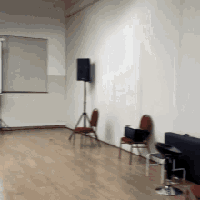 an empty room with chairs and a projector on the wall