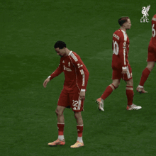 a soccer player with the number 22 on his shorts is walking on the field