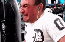 a man wearing headphones and a white shirt with a number 0 on it