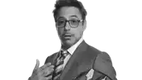 a man wearing glasses and a suit is making a funny face