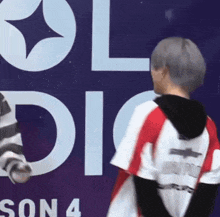 a person standing in front of a sign that says season 4