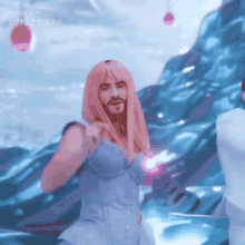a man with a beard wearing a pink wig is dancing in the water